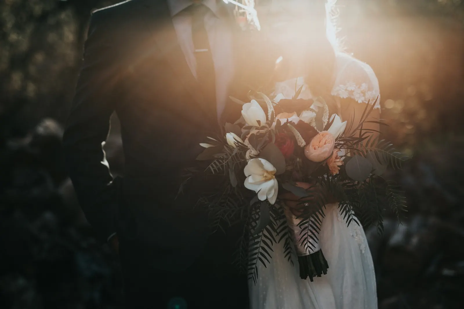 Moody close-up of a bride holding her bouquet
