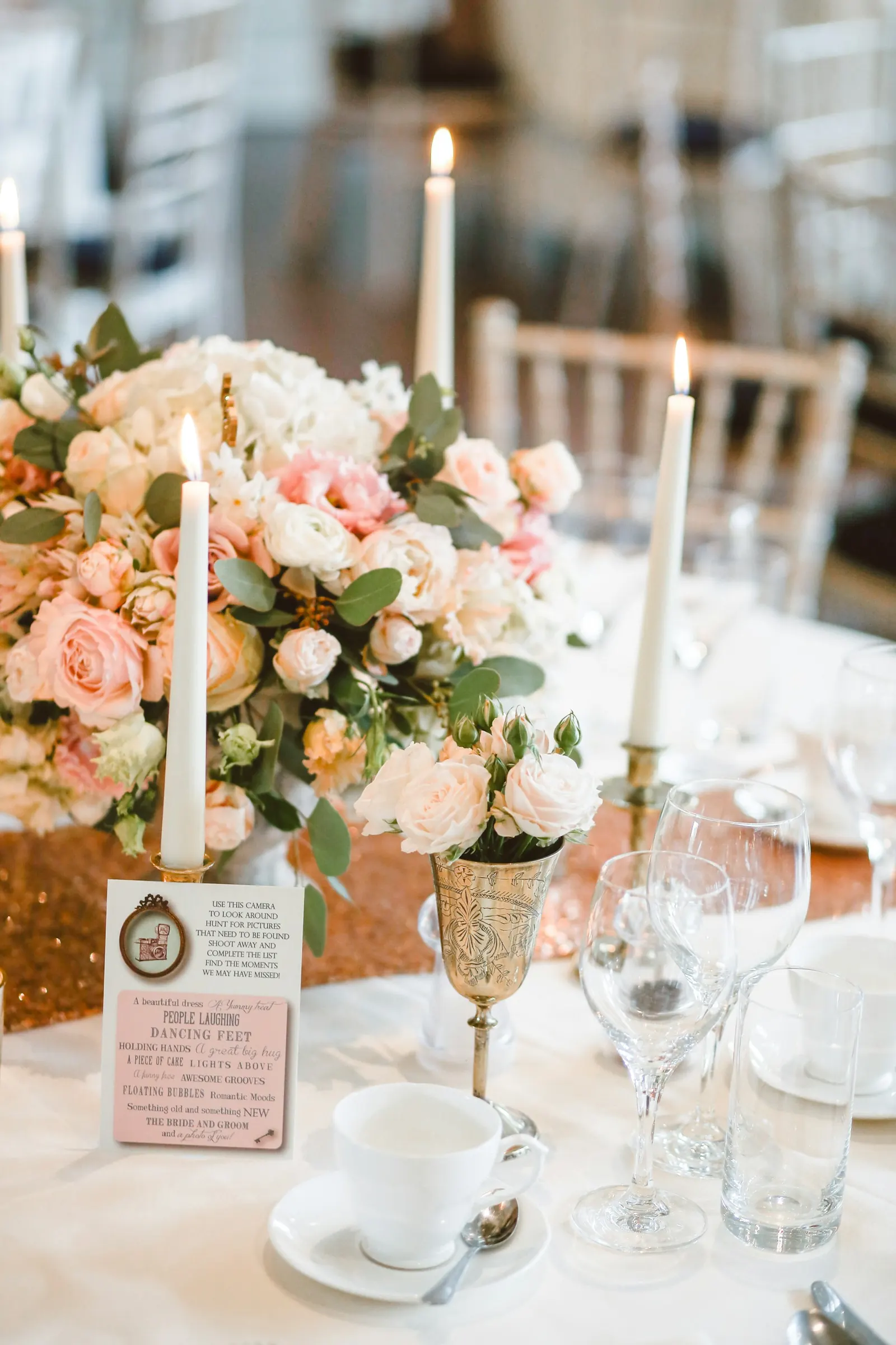 Reception table with tapered candles and blush florals